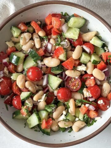 overhead view of cannellini bean salad in a bowl.