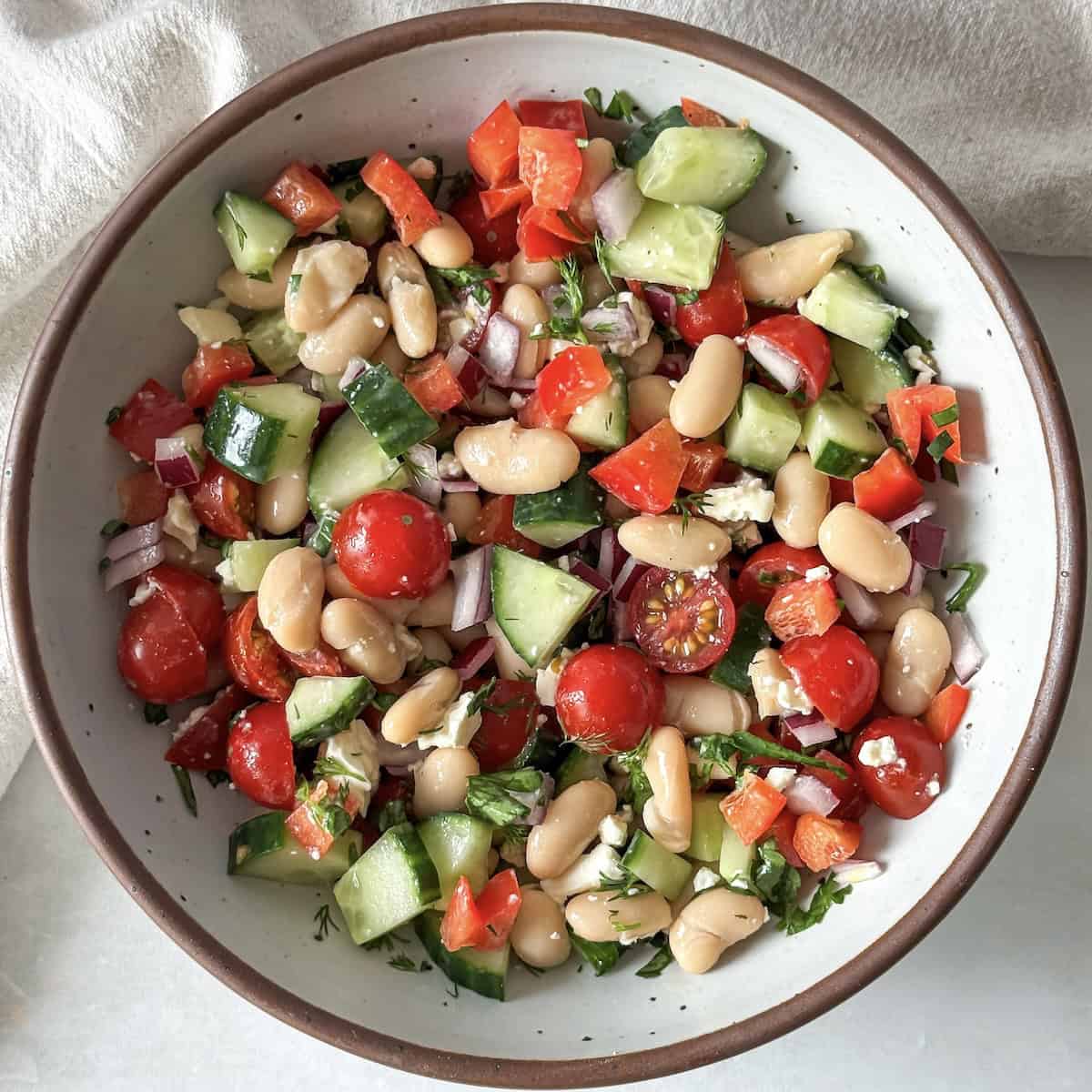 overhead view of cannellini bean salad in a bowl.