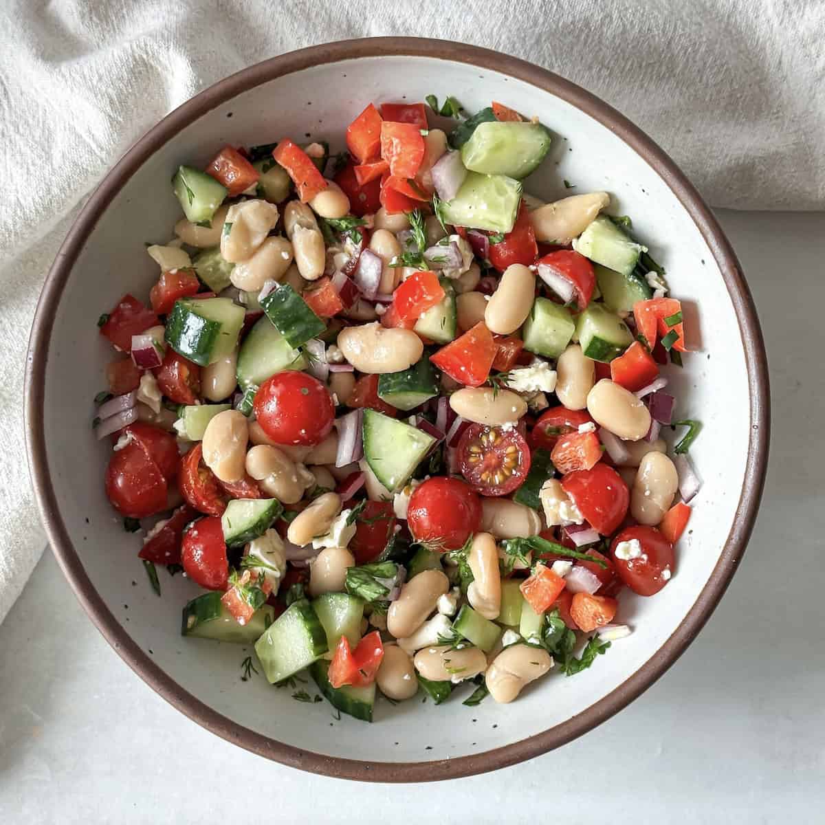 overhead view of cannellini bean salad in a bowl.
