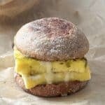 pesto egg sandwich on a parchment paper.