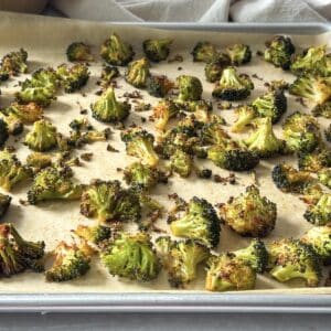 roasted broccoli on a sheet pan side view.