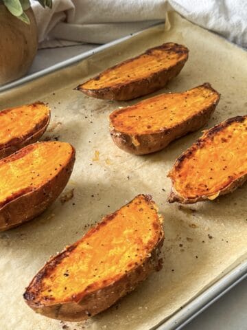 roasted sweet potato halves on a baking sheet.