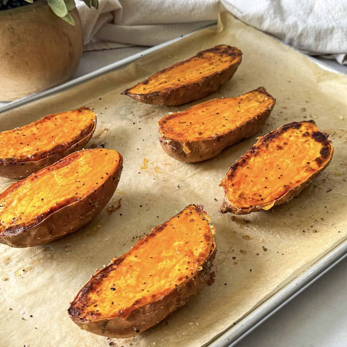 roasted sweet potato halves on a baking sheet.