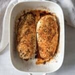 oven baked chicken breast in a baking dish overhead view.