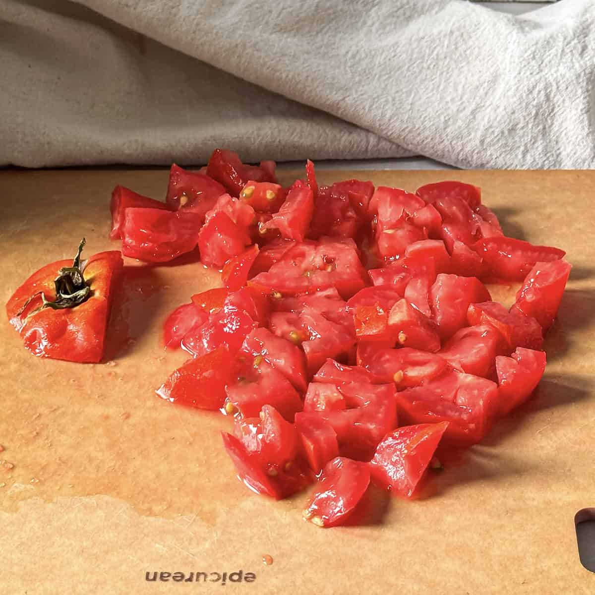 diced tomato on a cutting board.