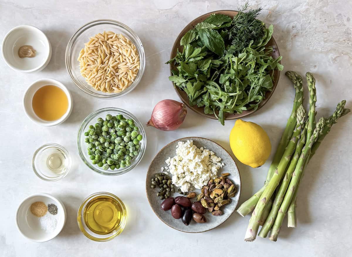 ingredients for spring orzo pasta salad on a table.