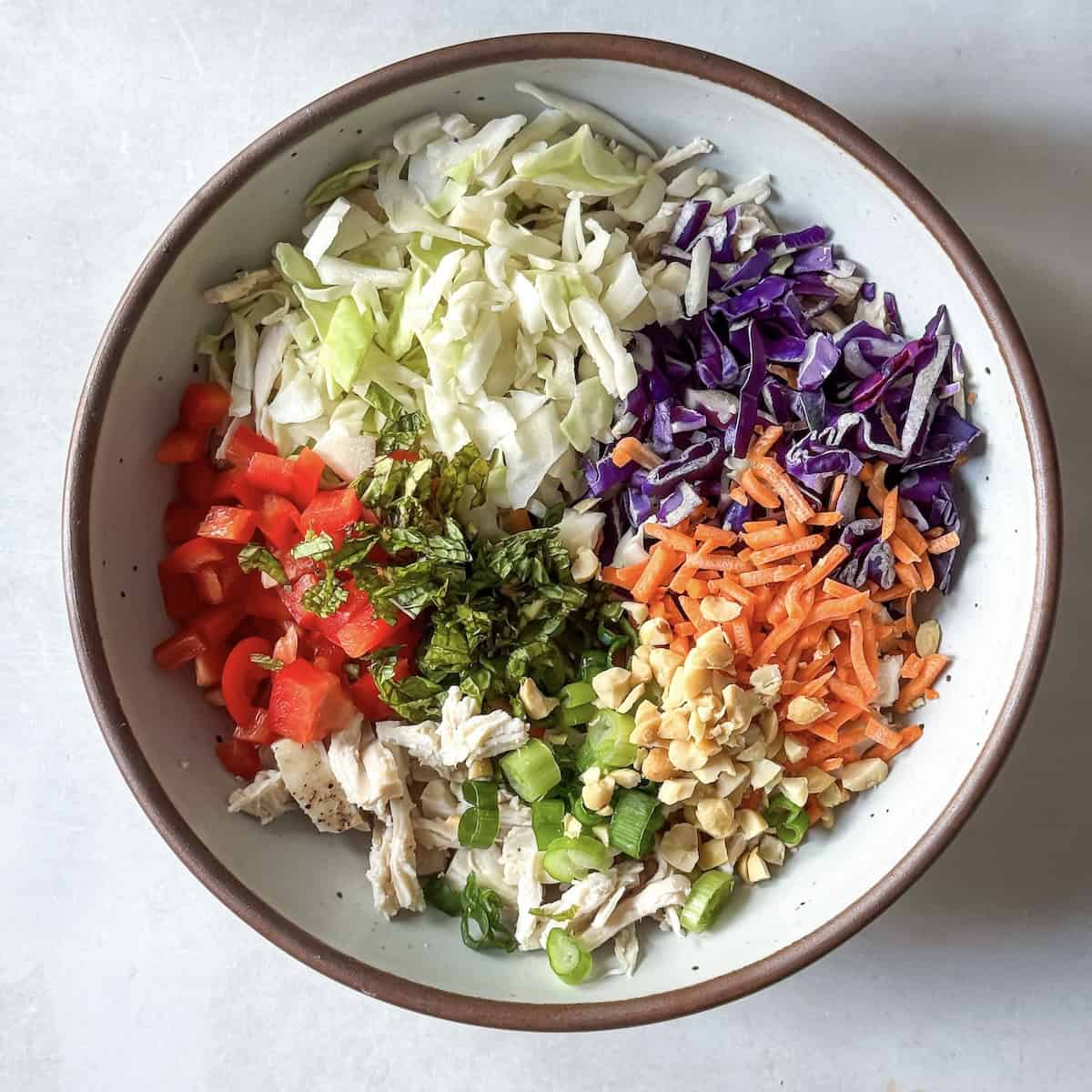 ingredients for thai chicken salad in a bowl..