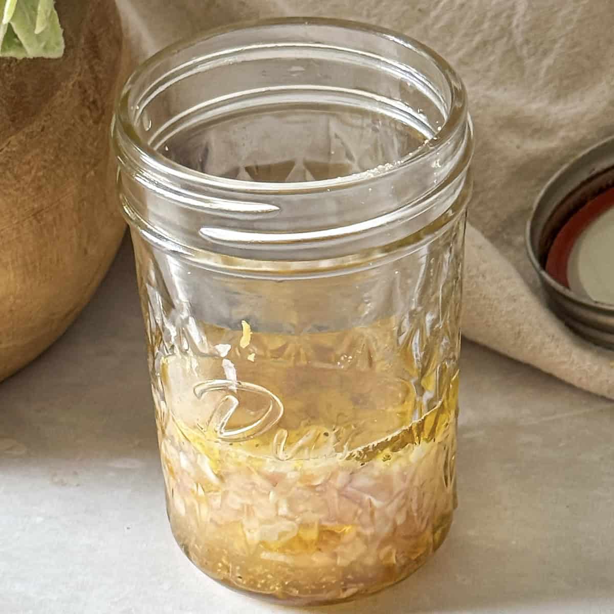 lemon shallot dressing in a mason jar.