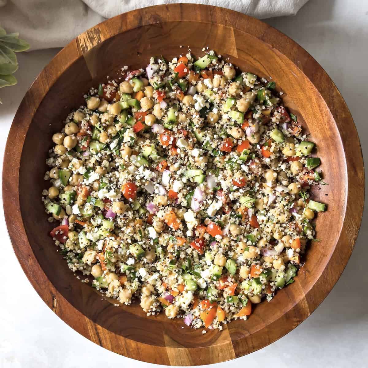 chickpea quinoa salad in a wooden bowl overhead view.