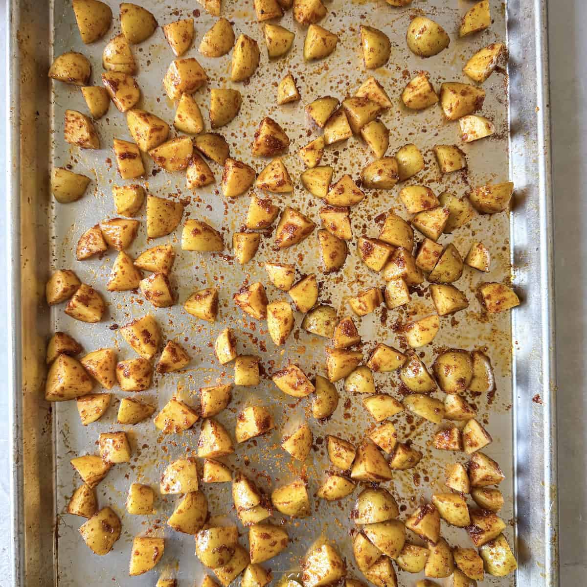 overhead view of roasted baby potatoes on a sheet pan before roasting.