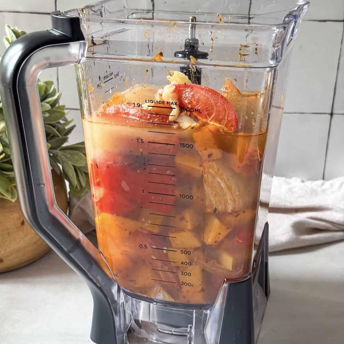Roasted butternut squash, tomatoes, red bell pepper, onion, garlic cloves in a blend with chicken broth and milk right before being blended into a soup.