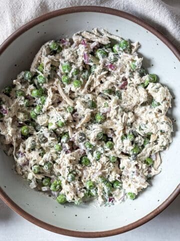 Chicken salad with peas right after being mixed together.