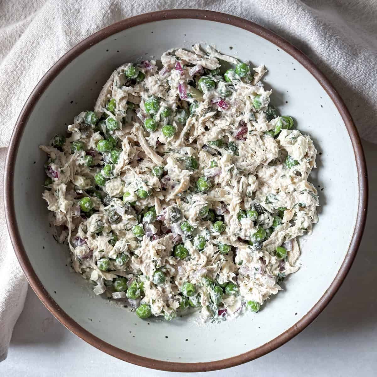 Chicken salad with peas right after being mixed together.